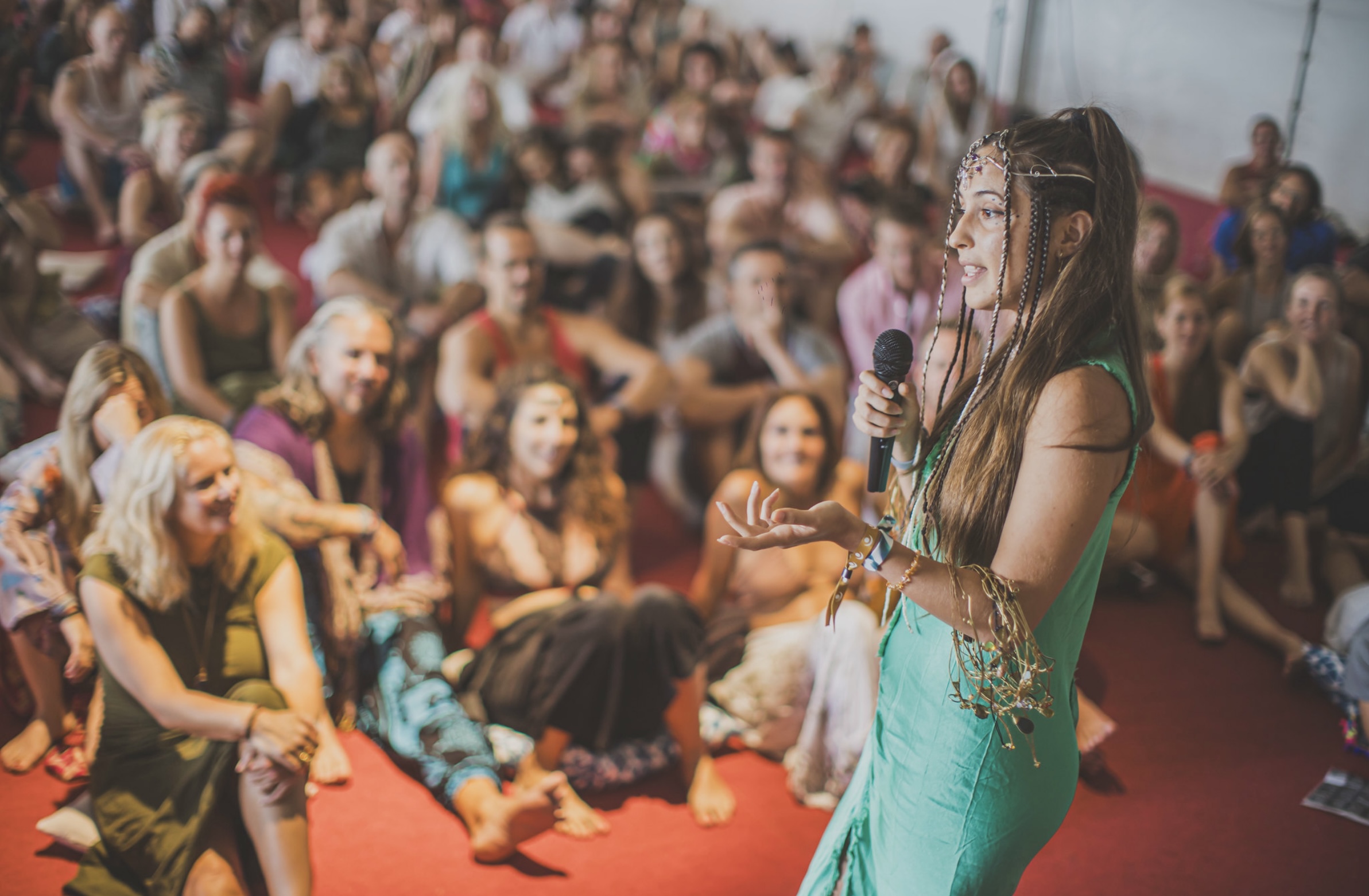 Adina Nicola singing before a large crowd at the Ibiza Tantra Festival 2023